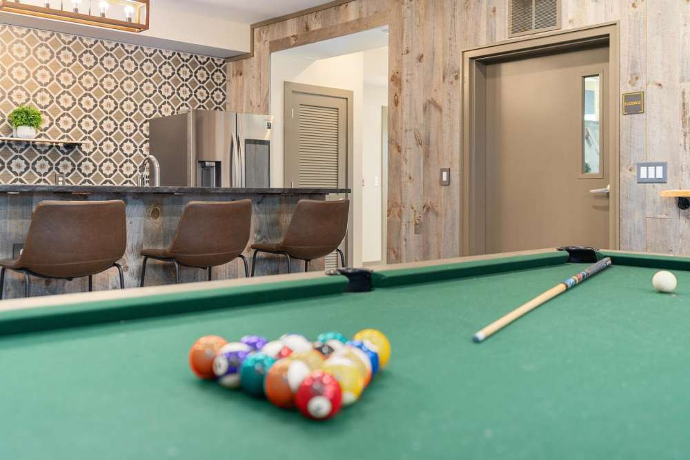 Resident clubhouse with a pool table at East of Market in Frederick, Maryland