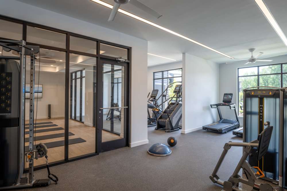 Resident fitness center with weight machines at Elms at the Refuge in Laurel, Maryland