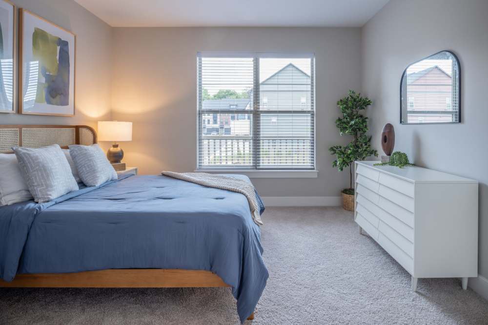 Spacious bedroom with queen size bed and dresser at Elms at the Refuge in Laurel, Maryland
