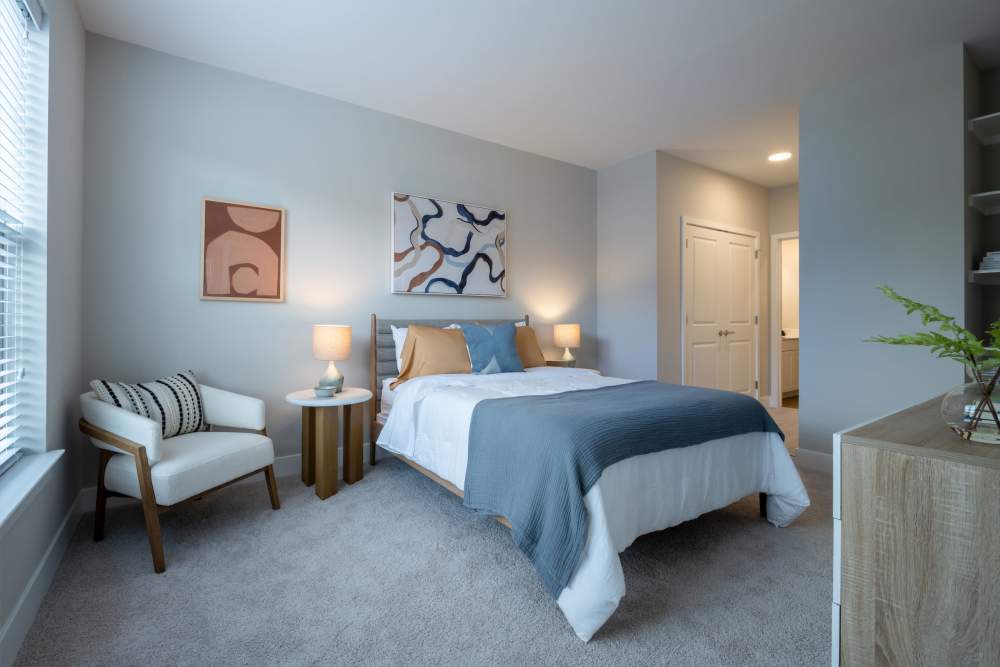 Spacious bedroom with queen size bed and dresser at Elms at the Refuge in Laurel, Maryland