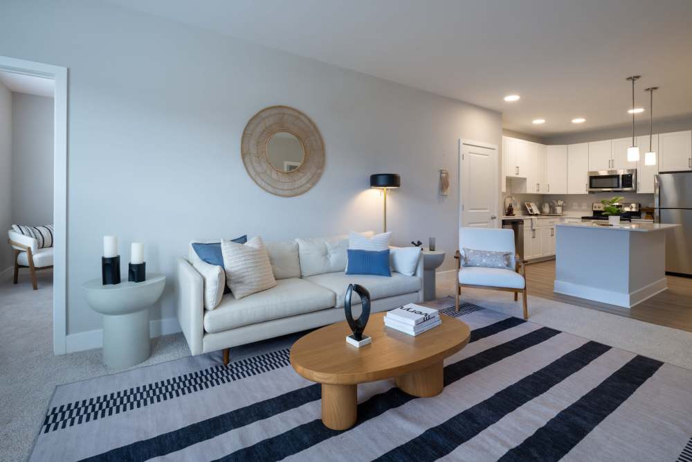 Spacious living rooms with hardwood-inspired flooring at Elms at the Refuge in Laurel, Maryland