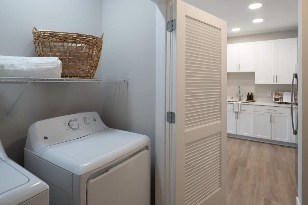 Laundry room with full-size washer and dryer at Elms at the Refuge in Laurel, Maryland
