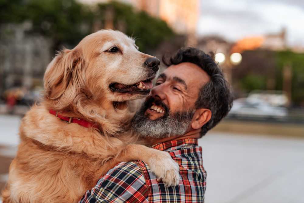 Resident hugging his dog Balmore at Ballantyne in Charlotte, North Carolina