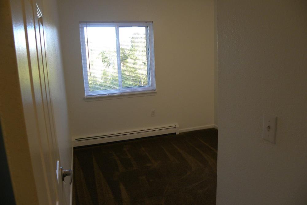 Bedroom with large windows at Copper Hills Apartments in Houghton, Michigan,
