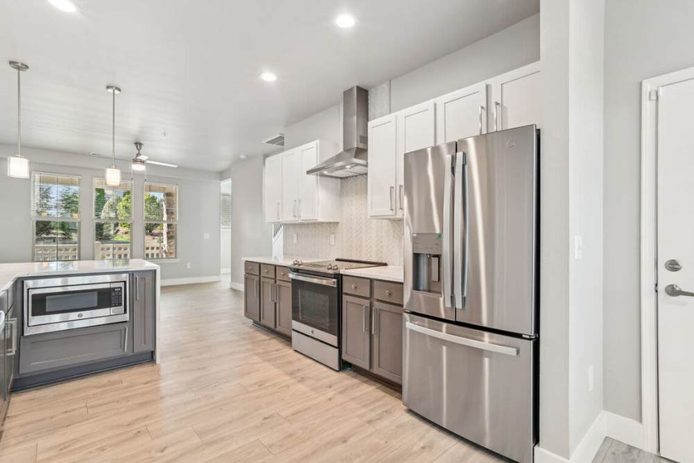 Living room with large windows at The Apartments at Brayden in Fort Mill, South Carolina