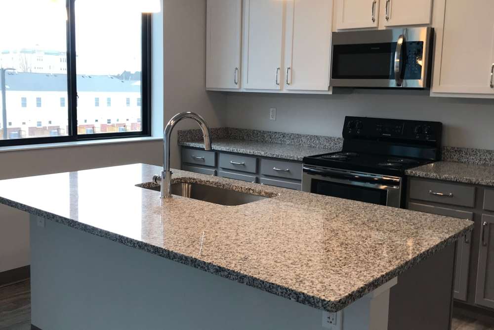 Model studio apartment with fully-equipped kitchen at Marketplace in Flint, Michigan