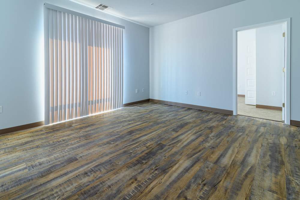 Open layout living room and hardwood-style flooring at Marketplace in Flint, Michigan