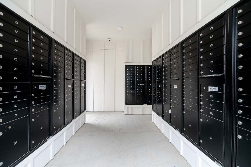 A hallway with many black lockers at parcHAUS AT CELINA PARKWAY in Celina, Texas