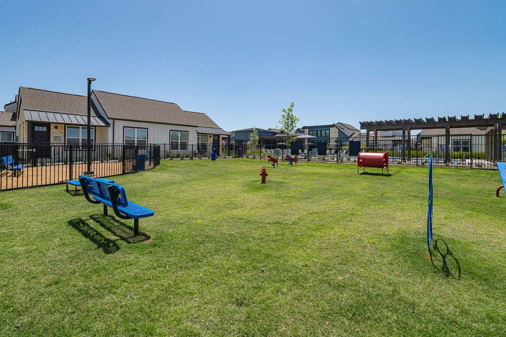 A playground with benches and a dog park at parcHAUS AT CELINA PARKWAY in Celina, Texas