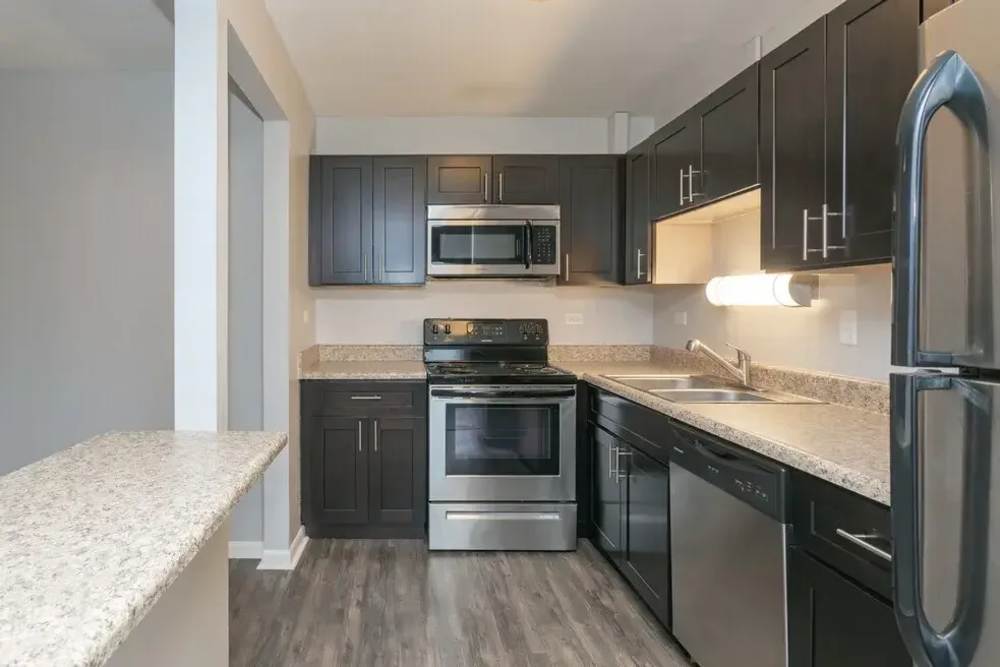 Kitchen with stainless-steel appliances at Mount Prospect Greens Apartments in Mt Prospect, Illinois