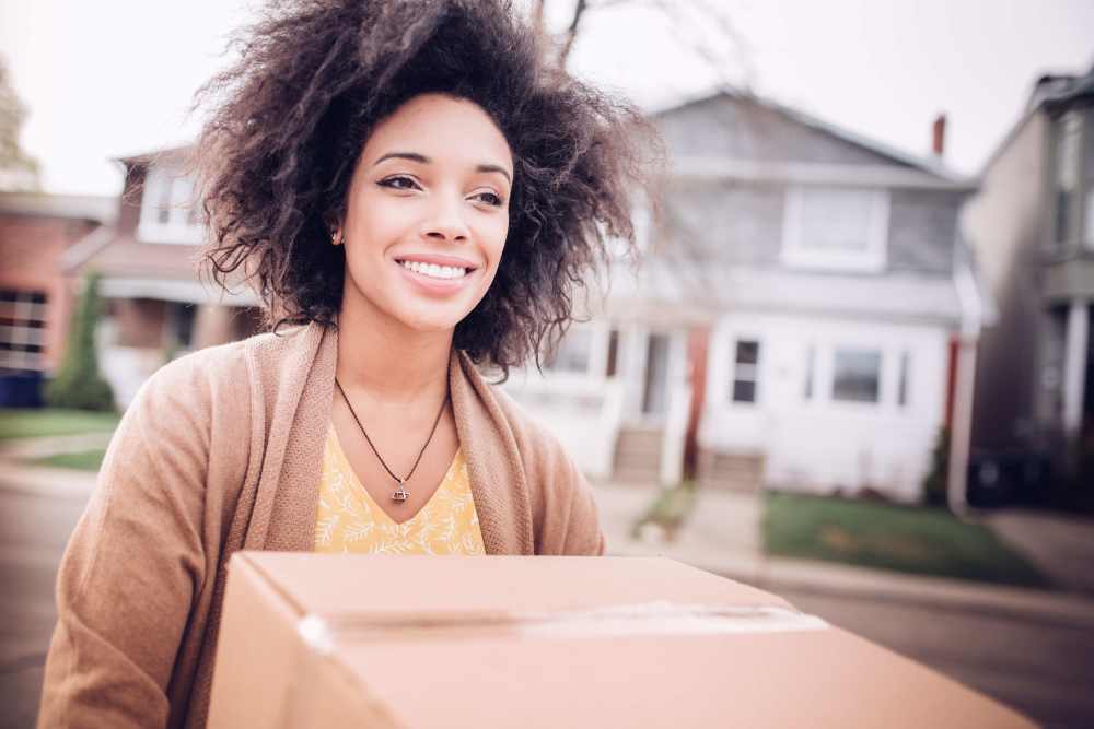 Woman carrying a box near Hometown Self Storage in Battle Ground, Washington