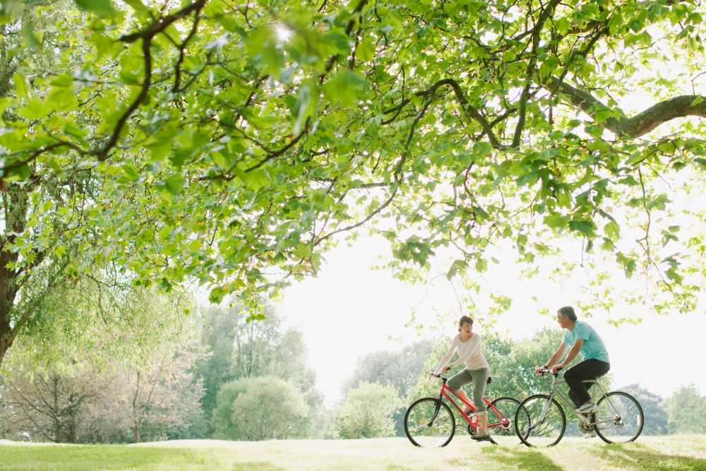 Residents biking in a park near Cross Creek in Columbus, Georgia