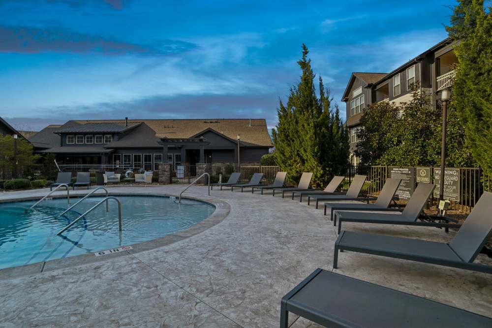 Lounge chairs by the pool at The Apartments at Brayden in Fort Mill, South Carolina