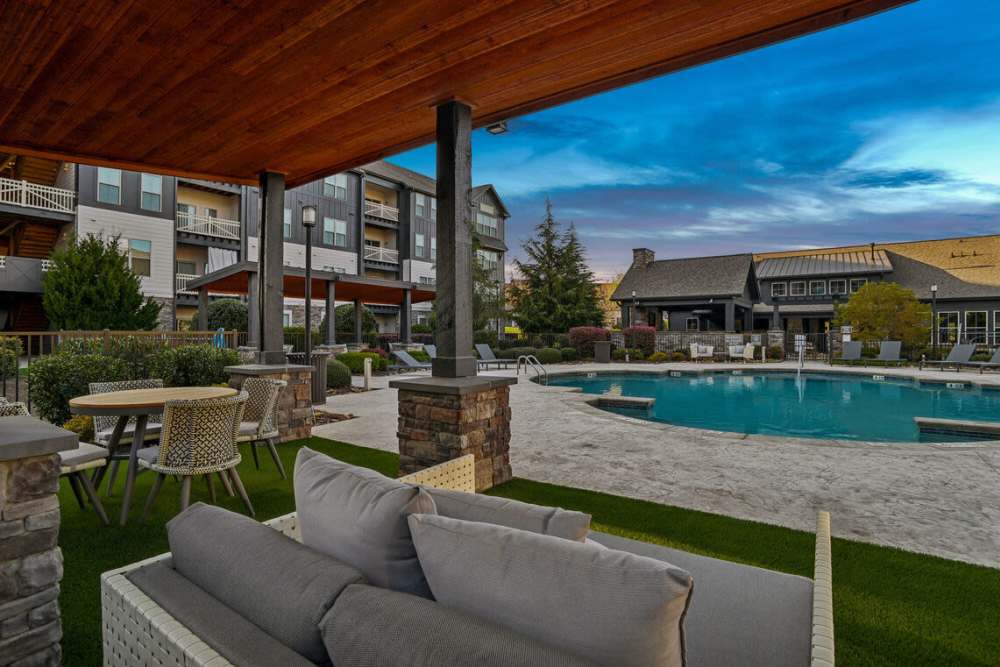 Comfy seating by the pool at The Apartments at Brayden in Fort Mill, South Carolina