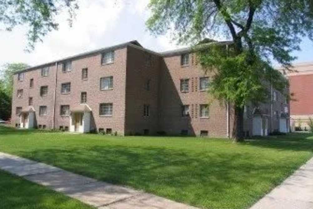 Walkway and green lawn outside the building at Chatham Grove Apartments in Chicago, Illinois