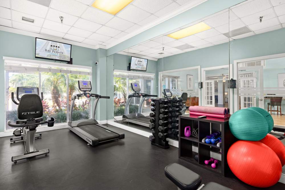 Community fitness center with cardio and weights at Bay Pointe Tower in South Pasadena, Florida