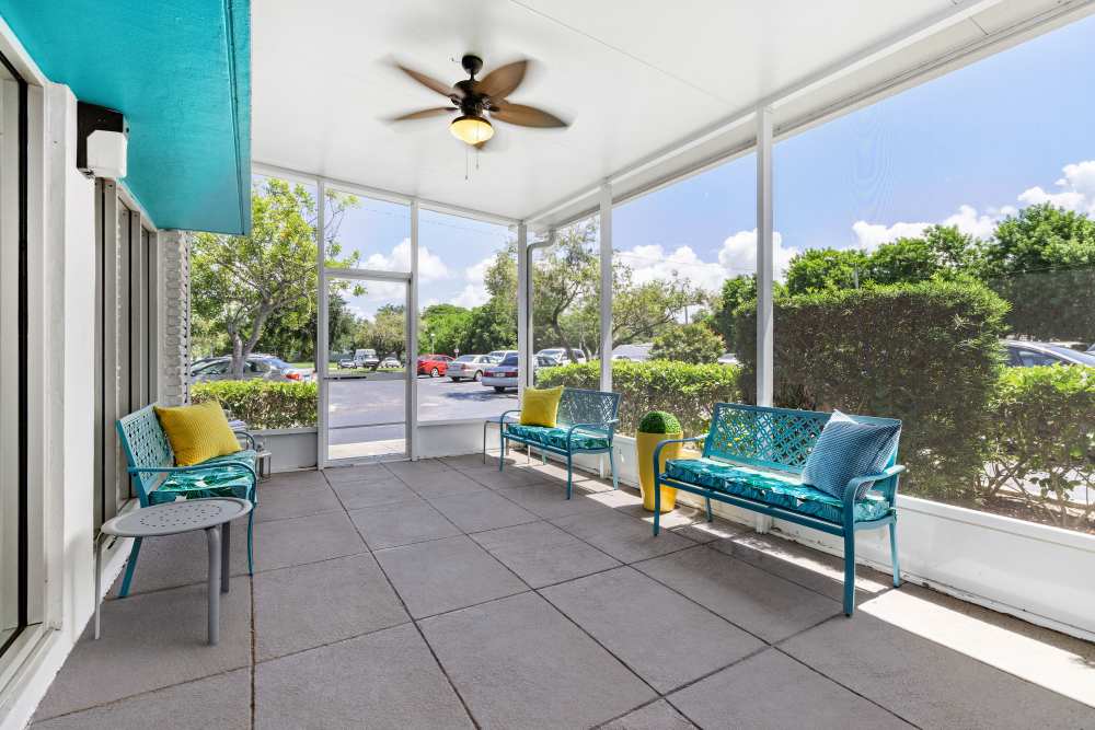 Patio seating with potted plants at Bay Pointe Tower in South Pasadena, Florida