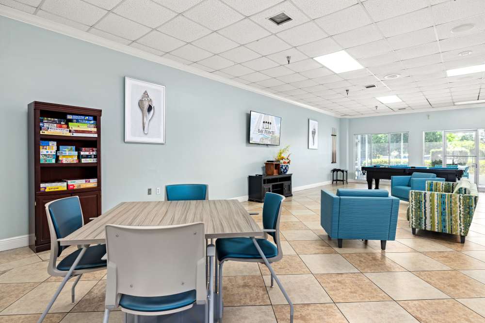 Resident game room with seating at Bay Pointe Tower in South Pasadena, Florida