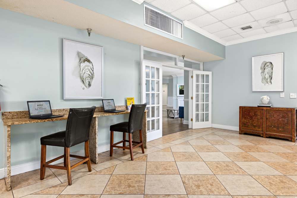 Resident clubhouse with seating and aquarium at Bay Pointe Tower in South Pasadena, Florida