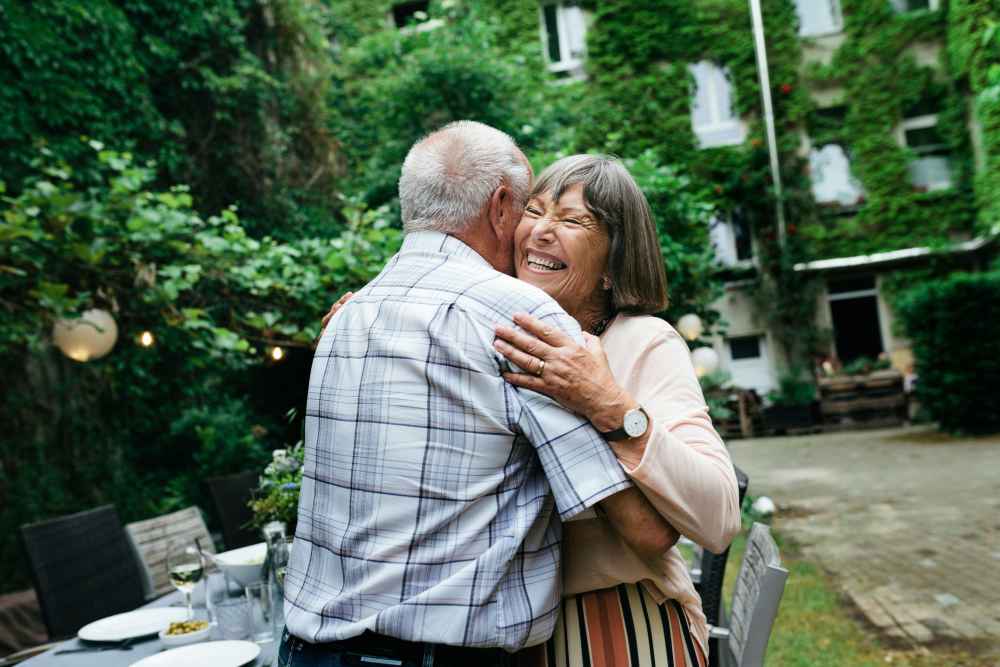 Residents hugging outdoors at Watermere Highlands in Arlington, Texas