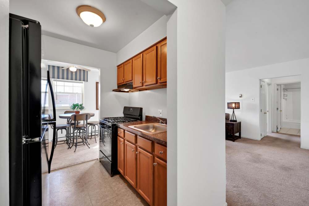 Galley kitchen and dining room of a model apartment at Ridgeview Apartment Homes in Reading, Pennsylvania