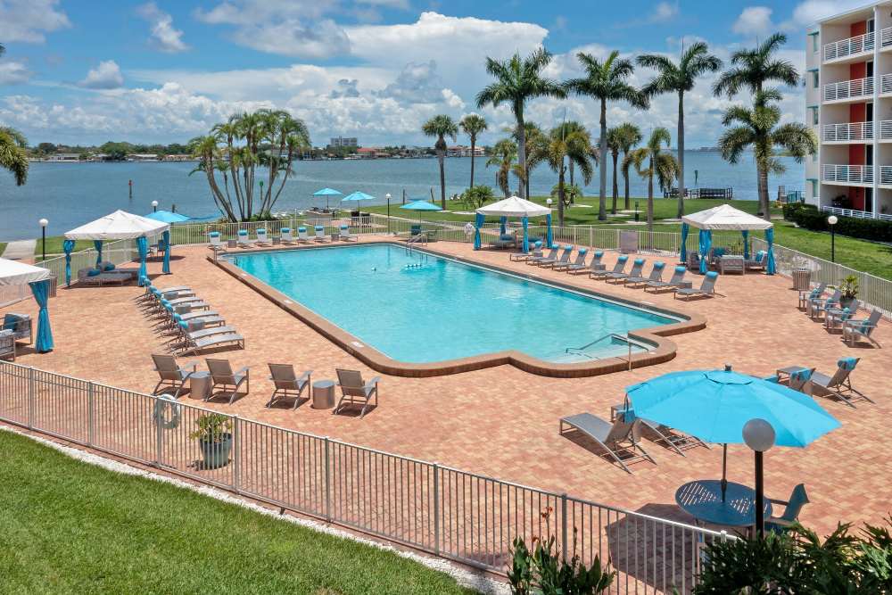 Pool deck and waterfront views at Waters Pointe in South Pasadena, Florida