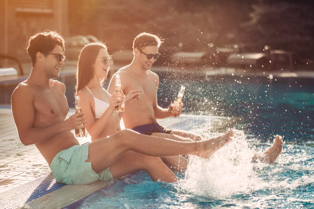 Residents splashing their feet in the pool at The Alder on Dabney in Richmond, Virginia