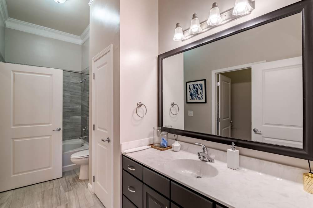 Spacious bathroom with a large vanity mirror at Echelon at Odenton in Odenton, Maryland