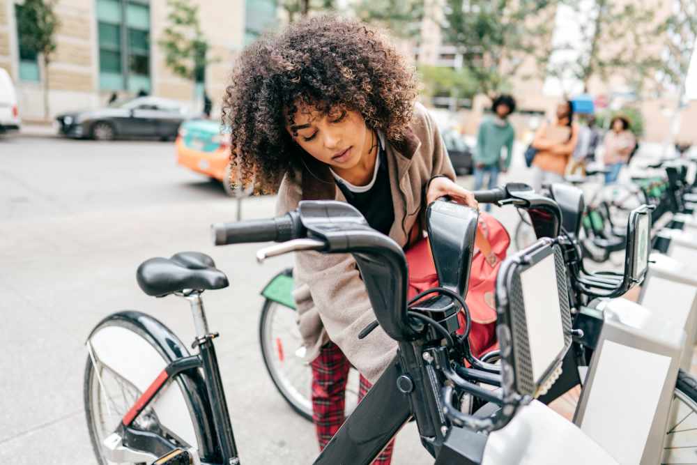 Woman checking her bike at Copper Square in Lancaster, California
