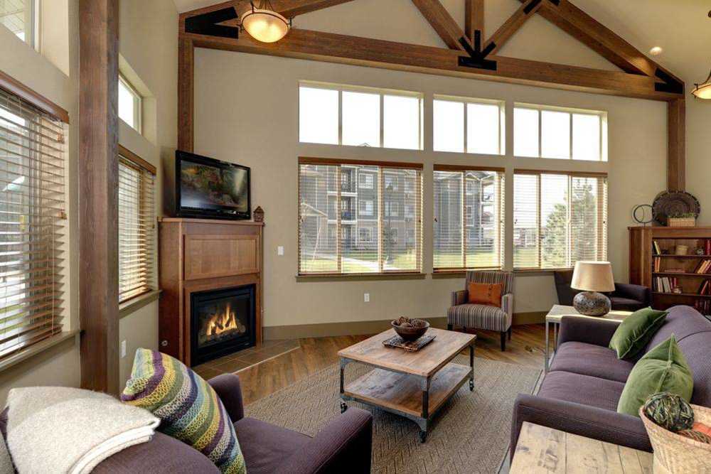 Spacious living room with ambient lighting, couch seating and a television at Copper Landing in Airway Heights, Washington