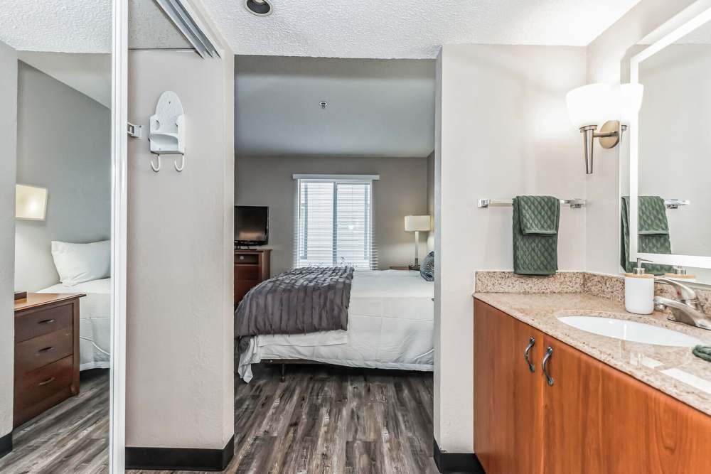 View of bedroom, closet and connecting bathroom at Vivo Living Charlotte in Charlotte, North Carolina, 
