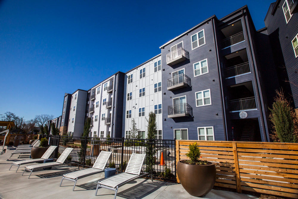 Apartments and poolside lounge chairs at Beacon Station in Augusta, Georgia