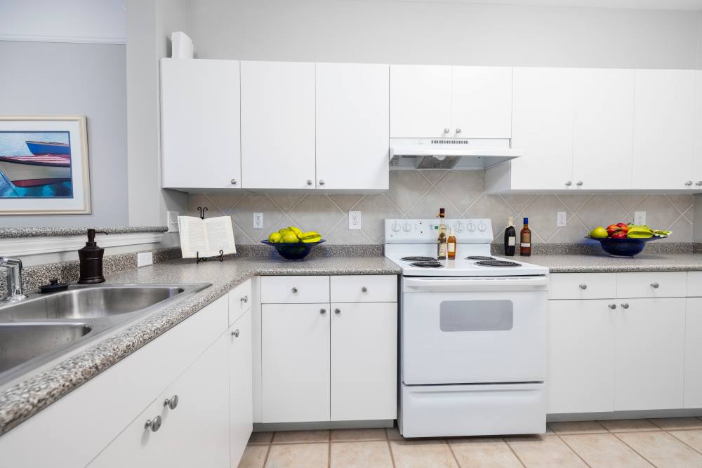 Spacious kitchen with white cabinetry in a model home at The Grove at Oakbrook in Summerville, South Carolina