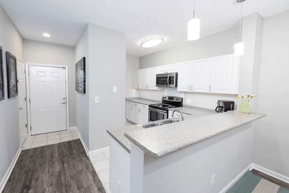 Kitchen and living room hallway with wood floors in a model home at Heron Reserve in Charleston, South Carolina