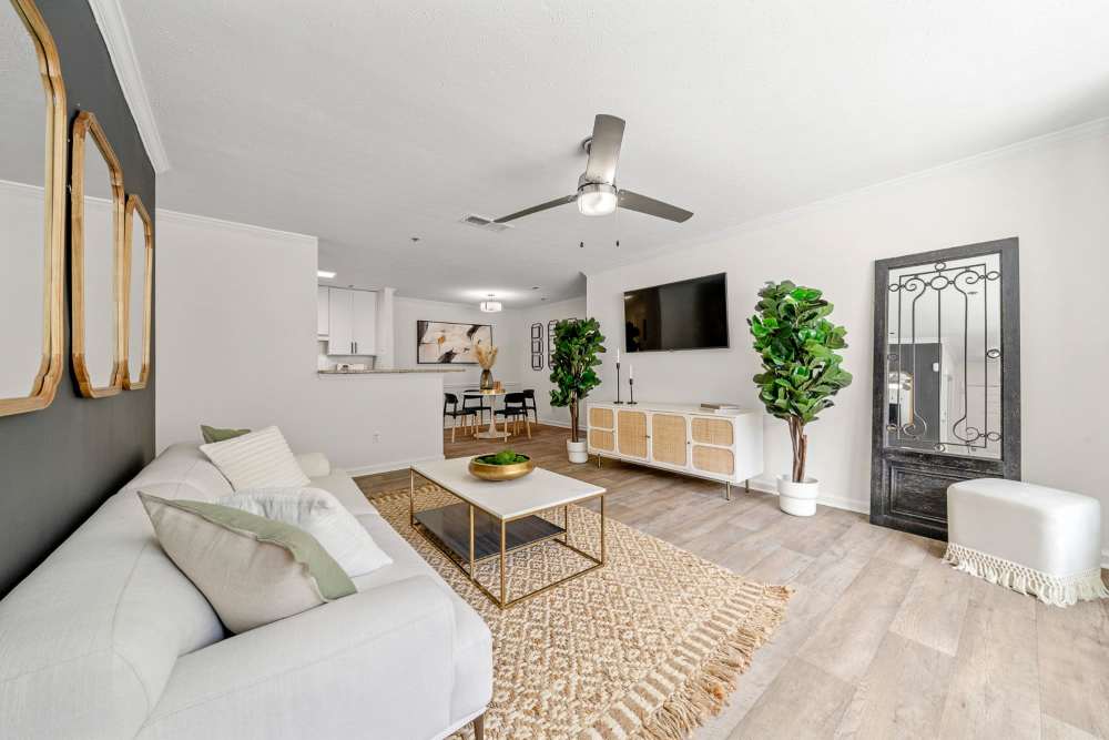 Living room with fan at The Seasons Apartments in Laurel, Maryland