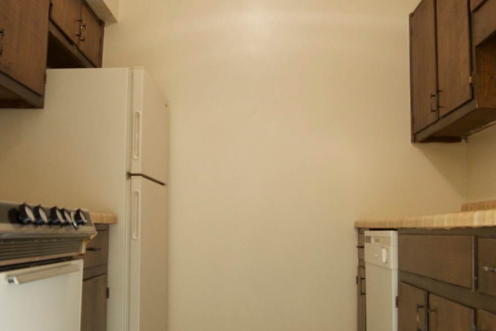 Kitchen with wood cabinetry at Cambridge Apartments in Athens, Georgia