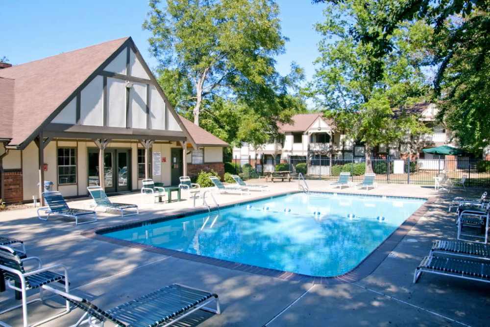 Swimming pool surrounded by greenery at Cambridge Apartments in Athens, Georgia