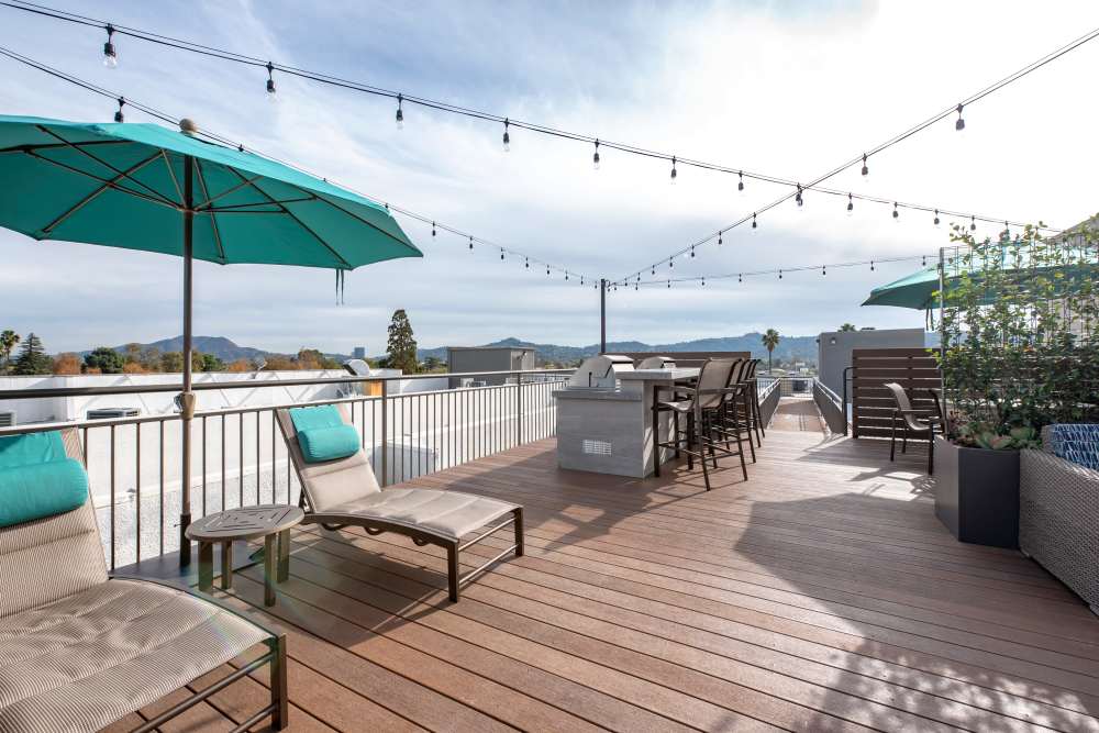 A large wooden balcony with lounge chairs at Vue at Laurel Canyon in Valley Village, California