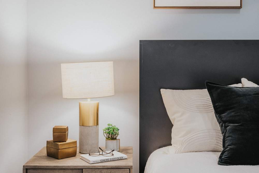 Bed and side table in a model home at The Addie in Savannah, Georgia