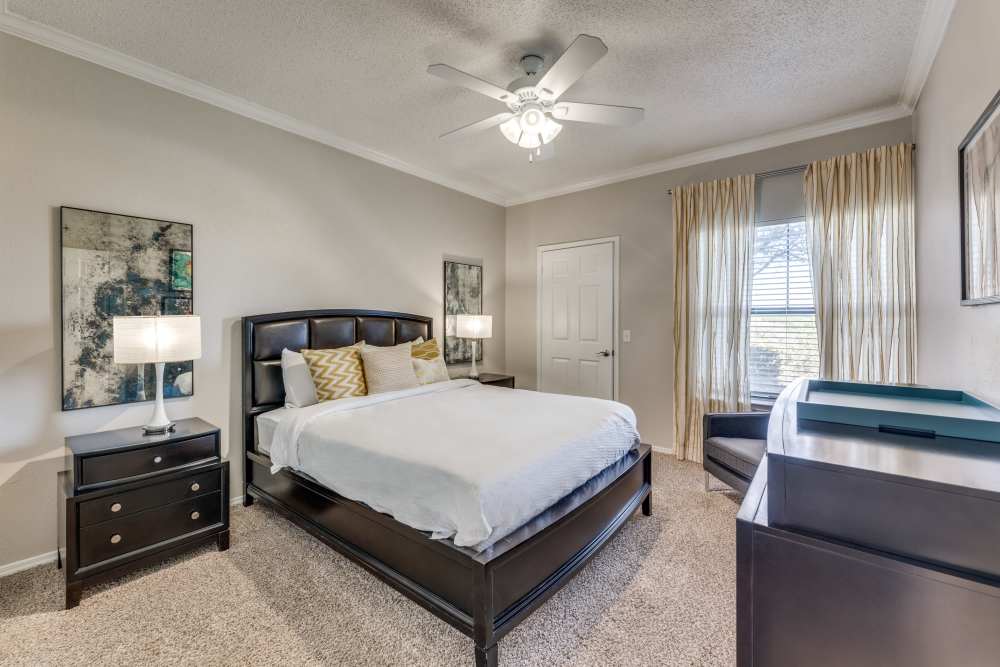 Apartment bedroom with a ceiling fan at Cliffs at Barton Creek in Austin, Texas