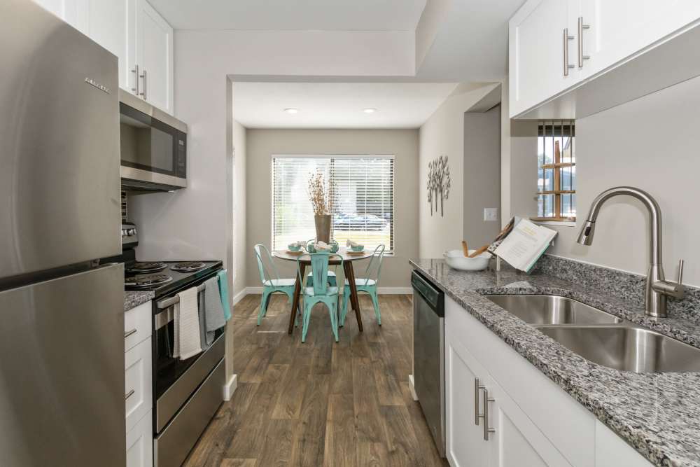 Fully equipped kitchen with white cabinetry and granite countertops at Parkside at Castleton Square in Indianapolis, Indiana