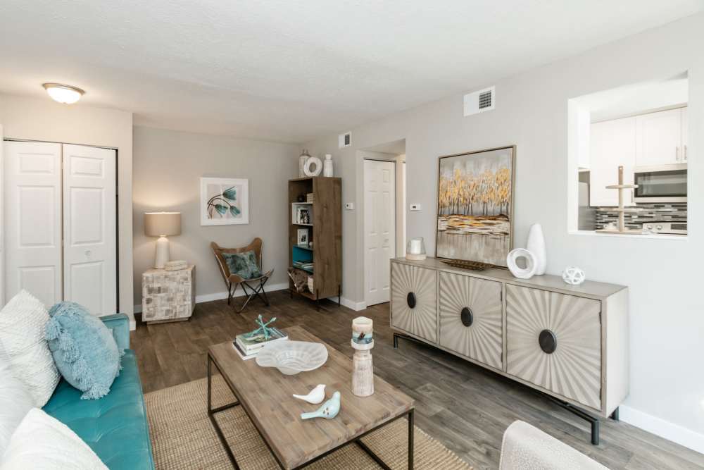 Living room of a model home with wood-style flooring at Parkside at Castleton Square in Indianapolis, Indiana