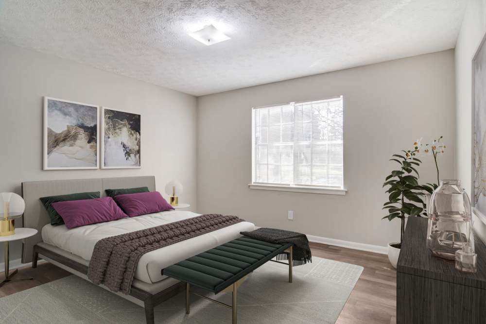 Apartment bedroom with wood-style flooring at Affinitee at Pine Lake in Stone Mountain, Georgia