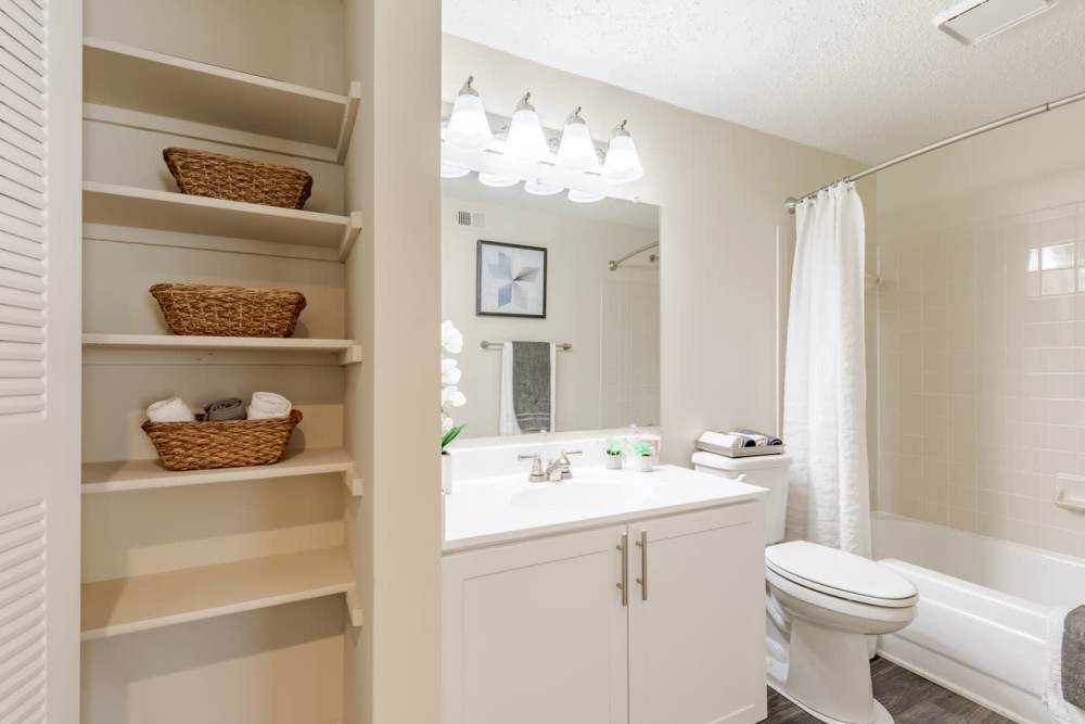 A bathroom with a toilet and sink at Kingscrest Apartments in Frederick, Maryland