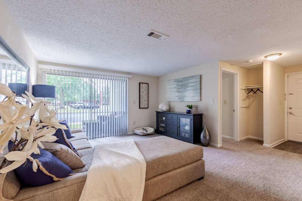 A living room with a couch and a bed at Kingscrest Apartments in Frederick, Maryland