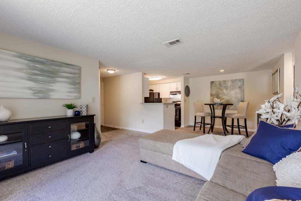 A living room with a couch and dining area at Kingscrest Apartments in Frederick, Maryland