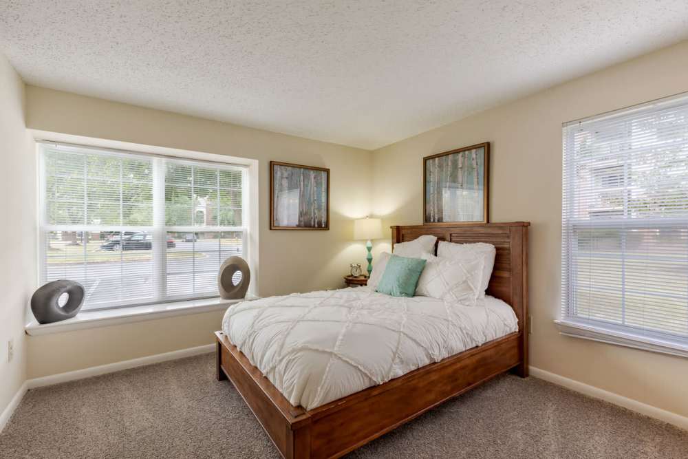 A bedroom with a bed and a window at Kingscrest Apartments in Frederick, Maryland