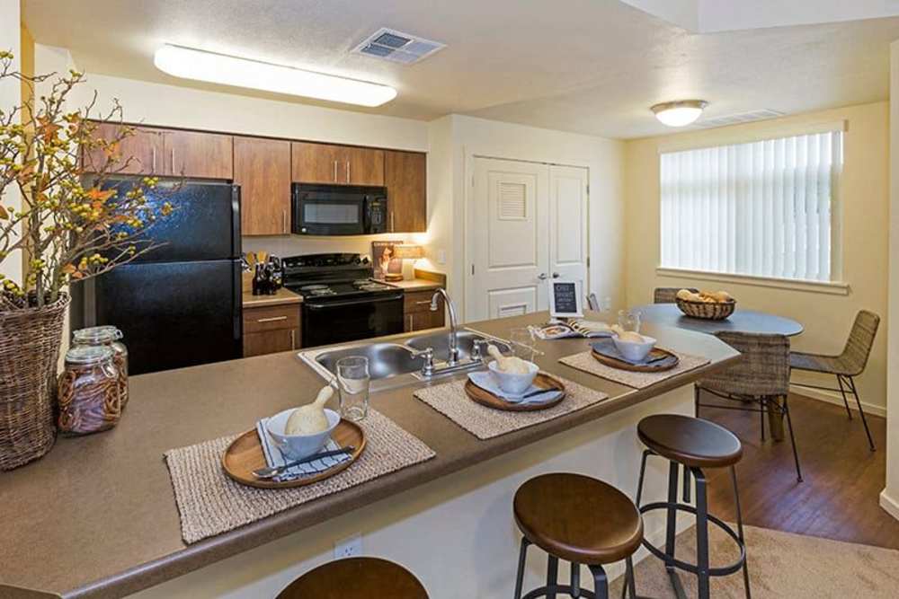 Kitchen with counter seating at Copper Valley in Puyallup, Washington