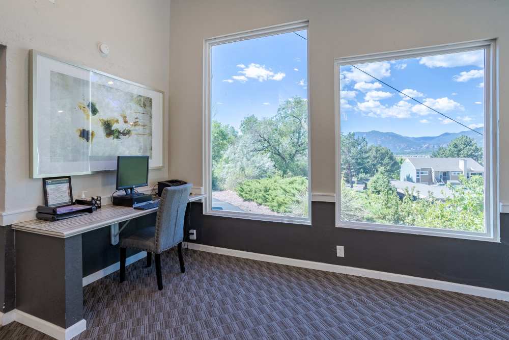 Reception Lounge Area with Sunny Outdoor View at The Knolls at Sweetgrass Apartment Homes in Colorado Springs, Colorado.