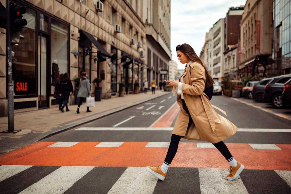 Woman crossing a street near The Daley at Shady Grove Metro in Rockville, Maryland